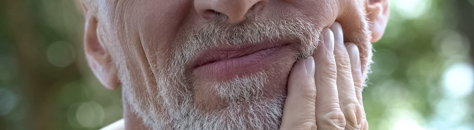 older man with tooth pain