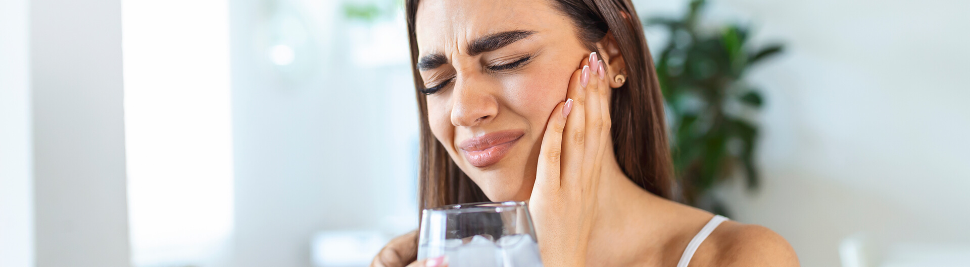 woman holding her face in pain