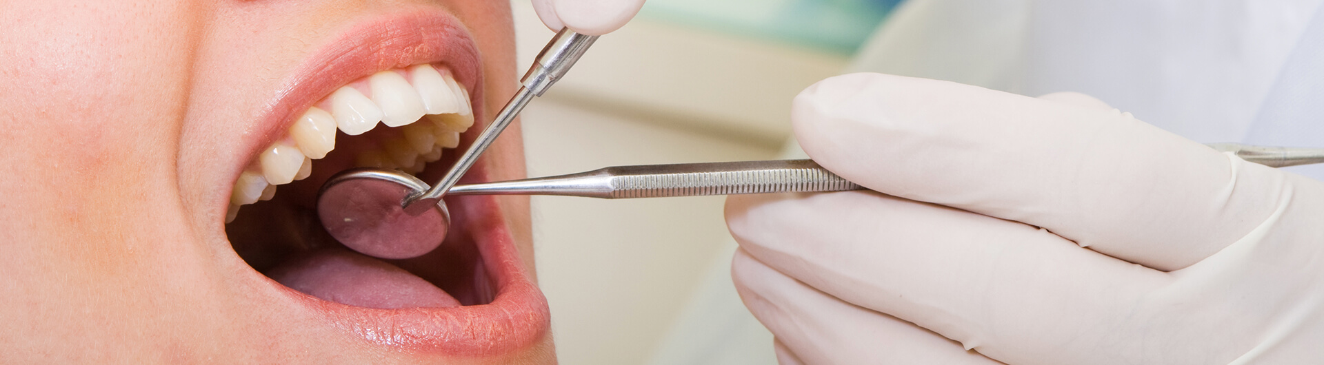 dental hygienist performing a cleaning